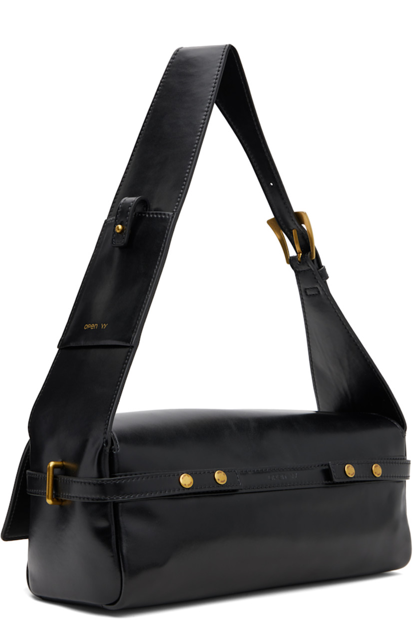 Buffed leather shoulder bag.

· Adjustable pin-buckle shoulder strap
· Patch pocket and logo stamp at strap
· Post-stud strap at face
· D-ring at sides
· Integrated strap with adjustable press-studs at back face
· Embossed logo at back face
· Flap closure
· Patch pocket at interior
· Twill lining
· Brass-tone hardware
· H5.5" x W11" x D4.5"

Supplier color: Black