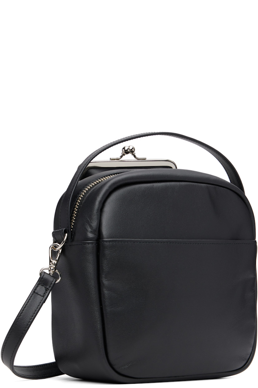 Buffed leather shoulder bag.

· Fixed carry handle
· Adjustable and detachable crossbody strap
· Patch pocket at face and back face
· Logo embossed at face
· Zip closure
· Cotton twill lining
· H7.75" x W7" x D3"

Supplier color: Black