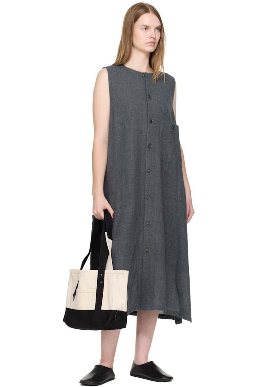 Cotton canvas tote.

· Fixed twin shoulder straps
· D-ring at face
· Patch pocket at face and back face
· Press-stud closure
· Bottle sleeve at interior
· Unlined
· H9.5" x W18" x D4"

Supplier color: Off white