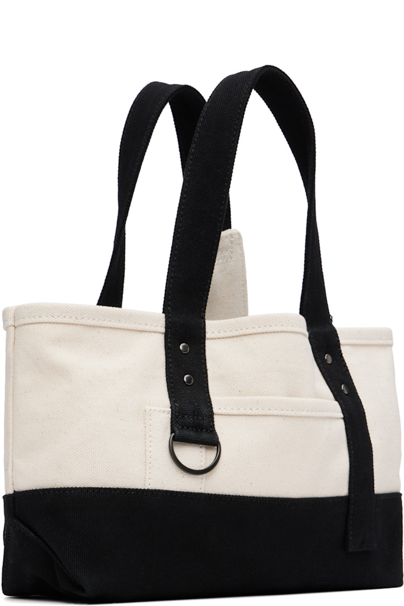 Cotton canvas top handle bag.

· Fixed twin carry handles
· D-ring at face
· Patch pocket at face and back face
· Press-stud closure
· Bottle sleeve at interior
· Unlined
· H6" x W12.5" x D3.5"

Supplier color: Off white