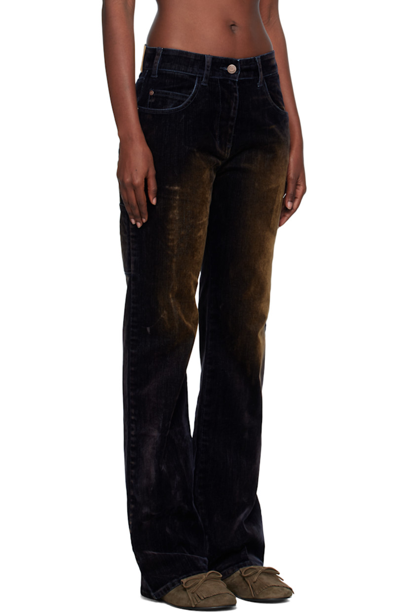 Flocked stretch denim jeans.

· Fading throughout
· Belt loops
· Five-pocket styling
· Zip fly
· Logo patch at back waistband
· Patch pockets at back leg
· Logo-engraved antiqued copper-tone hardware

Supplier color: Black