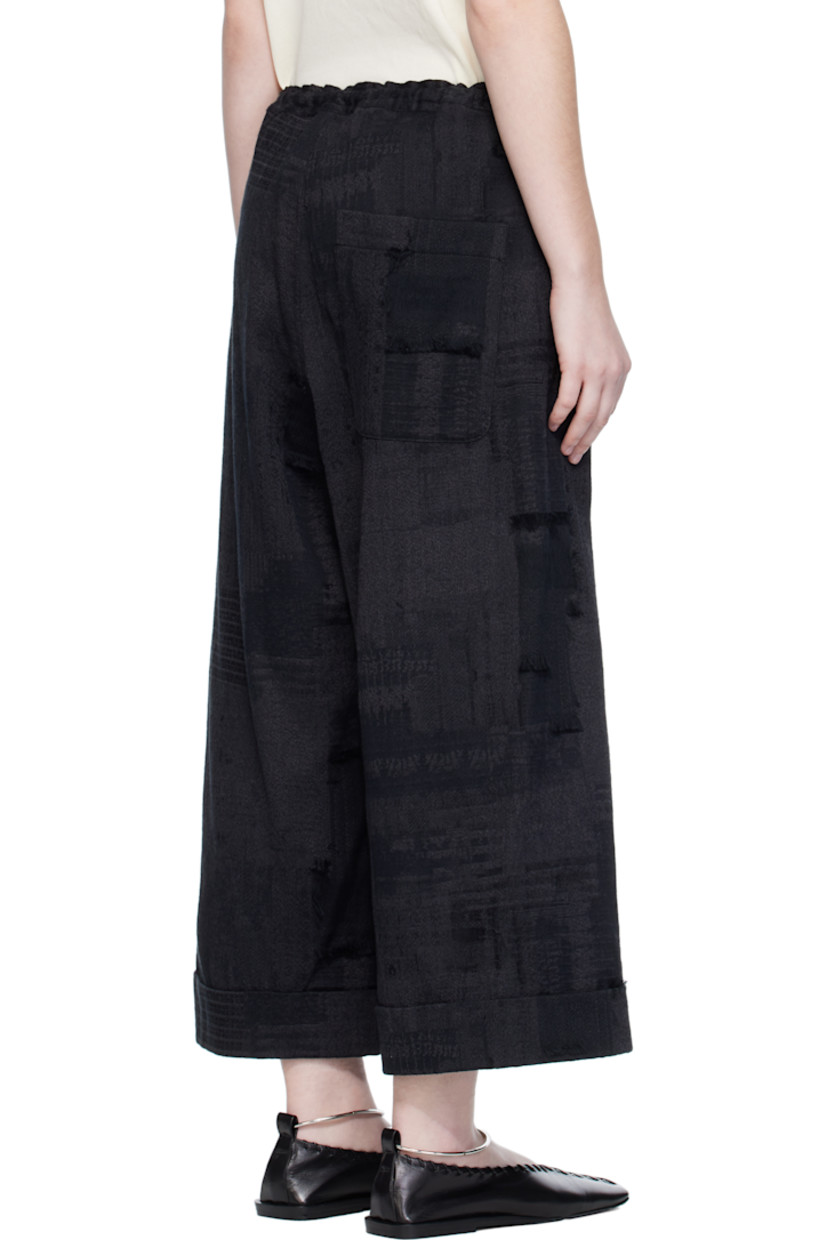Wide-leg woven cotton trousers.

· Jacquard and fil-coupé pattern throughout
· Concealed drawstring at elasticized waistband
· Three-pocket styling
· Zip fly
· Dropped inseam
· Rolled cuffs

Supplier color: Black