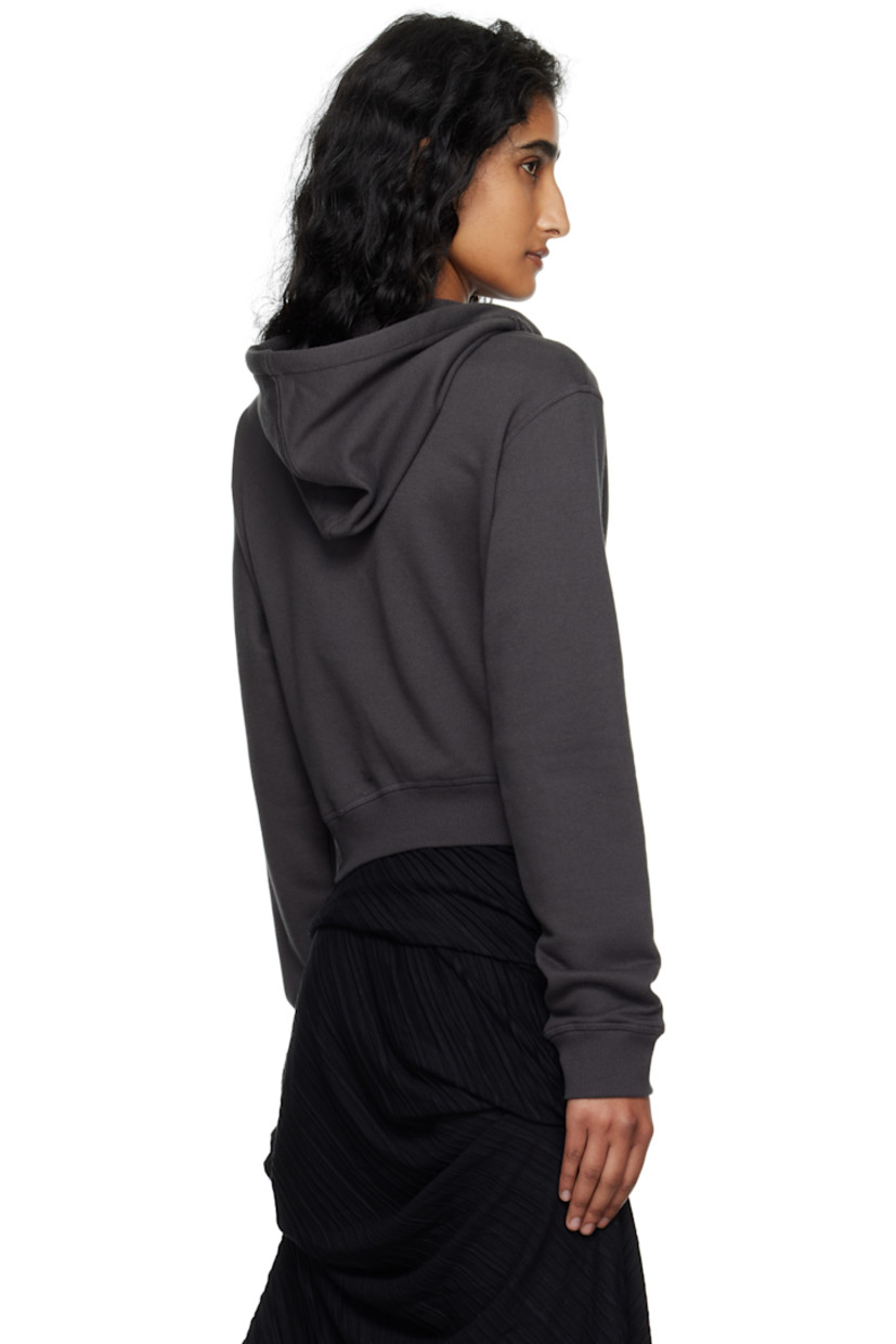 French terry hoodie.

· Drawstring at hood
· Zip closure
· Ruffled trim and patch pockets at front
· Rib-knit hem and cuffs

Supplier color: Charcoal