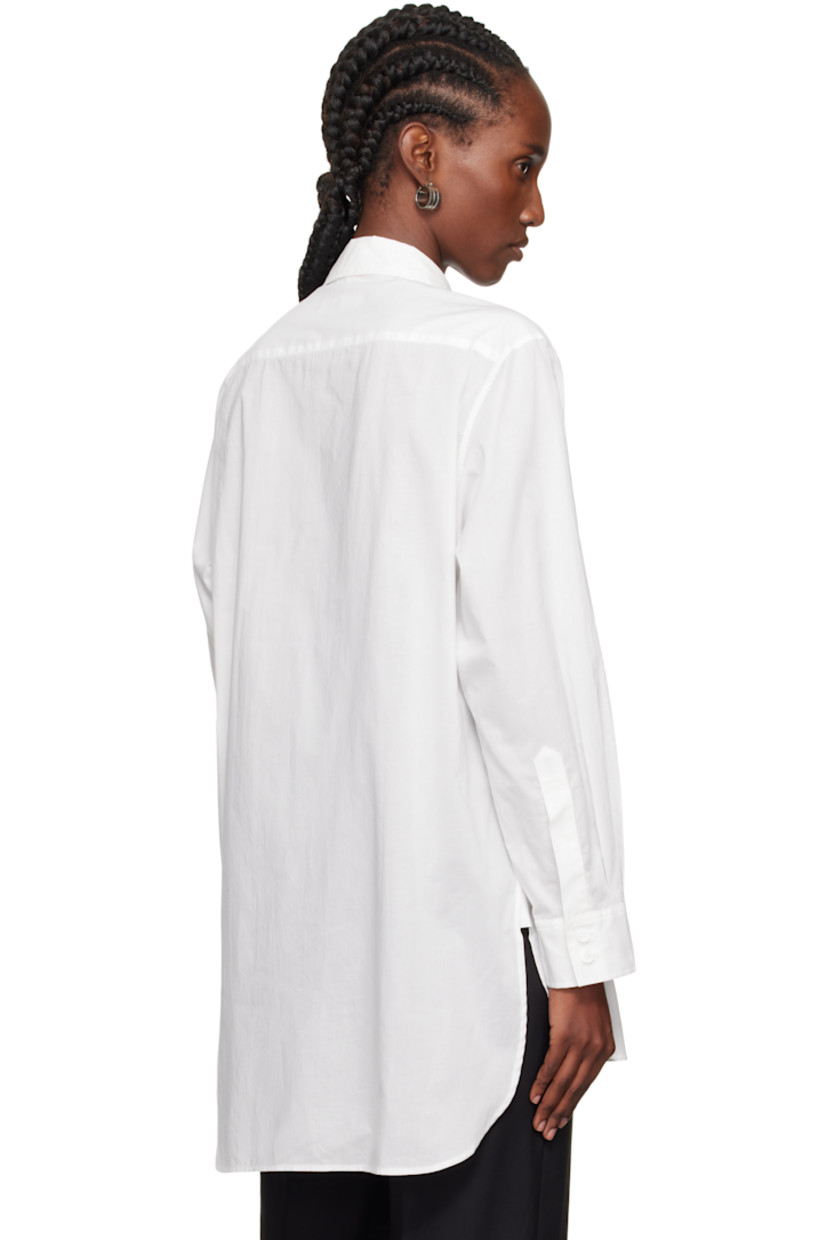 Cotton gauze shirt. 

· Spread collar 
· Ruffled appliqué at button closure 
· Droptail hem 
· Dropped shoulders
· Pleats at buttoned barrel cuffs

Supplier color: Off white