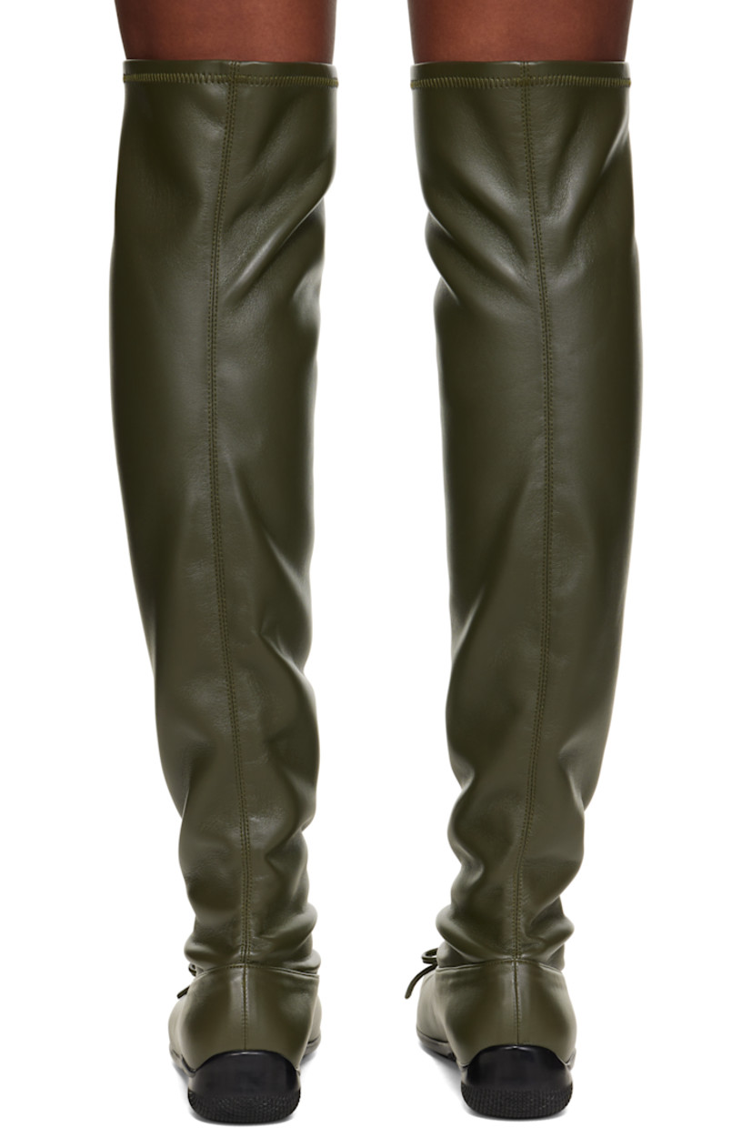Thigh-high grained faux-leather boots. 

· Square toe 
· Bow accent at vamp
· Treaded rubber sole

Supplier color: Khaki