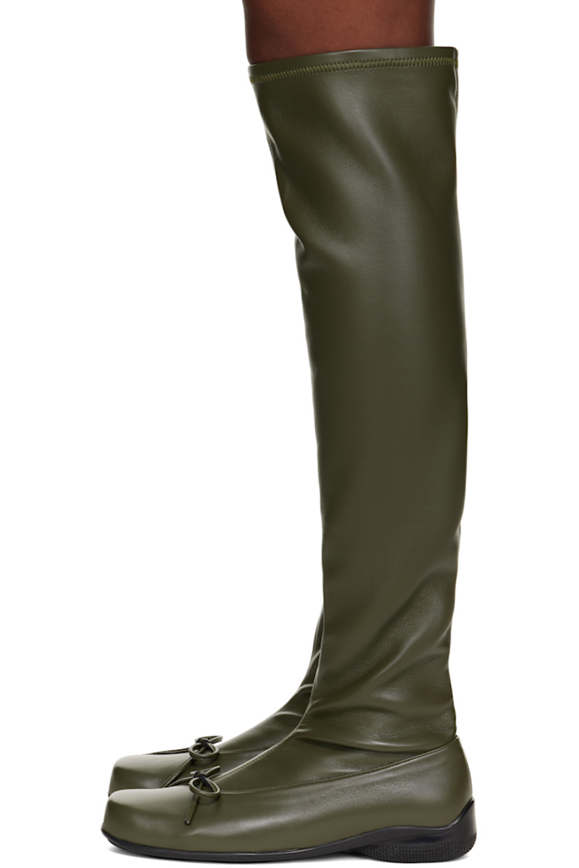 Thigh-high grained faux-leather boots. 

· Square toe 
· Bow accent at vamp
· Treaded rubber sole

Supplier color: Khaki
