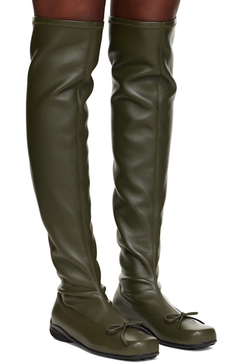 Thigh-high grained faux-leather boots. 

· Square toe 
· Bow accent at vamp
· Treaded rubber sole

Supplier color: Khaki