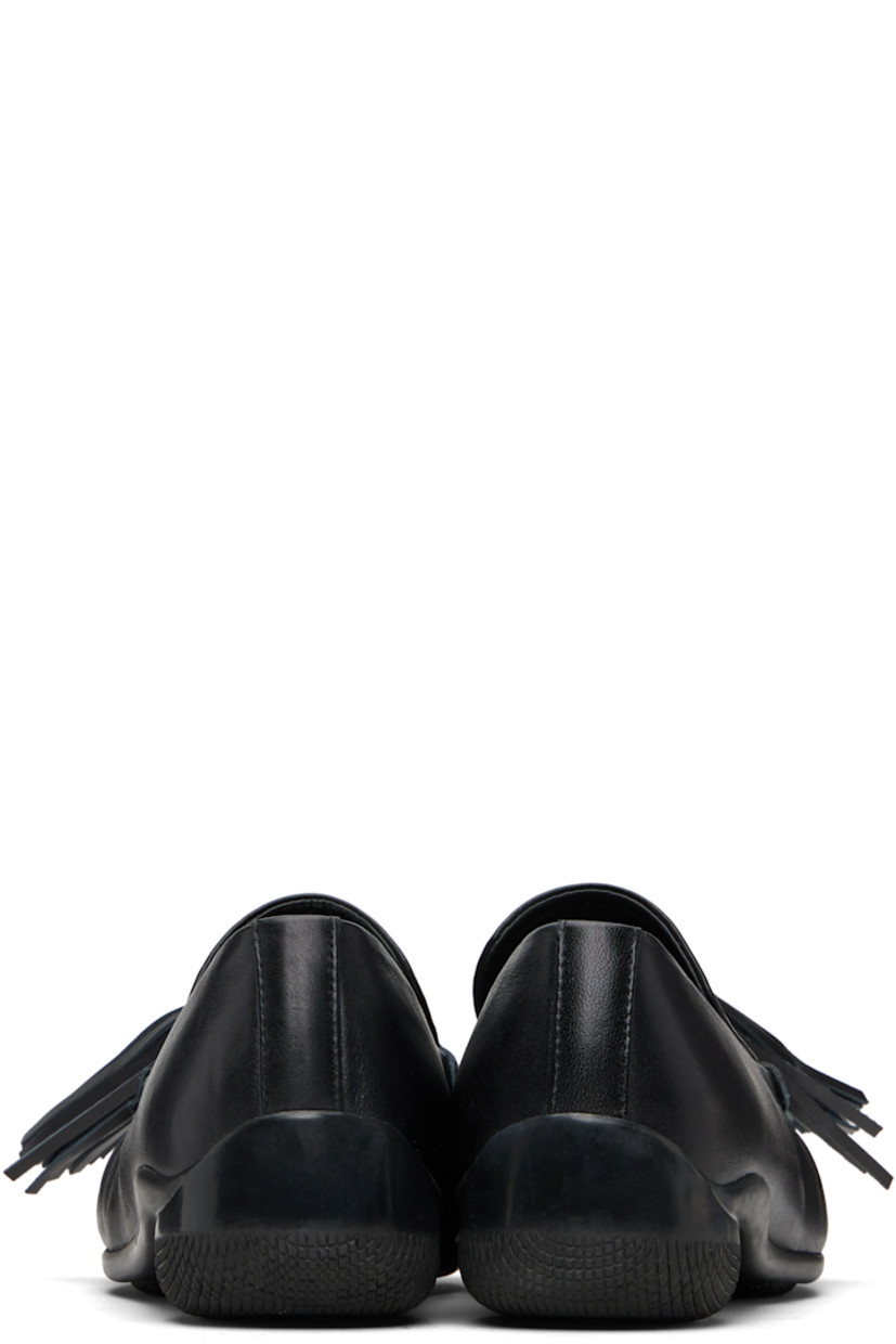 Buffed leather loafers.

· Square moc toe
· Tassels at vamp
· Treaded rubber sole

Supplier color: Black