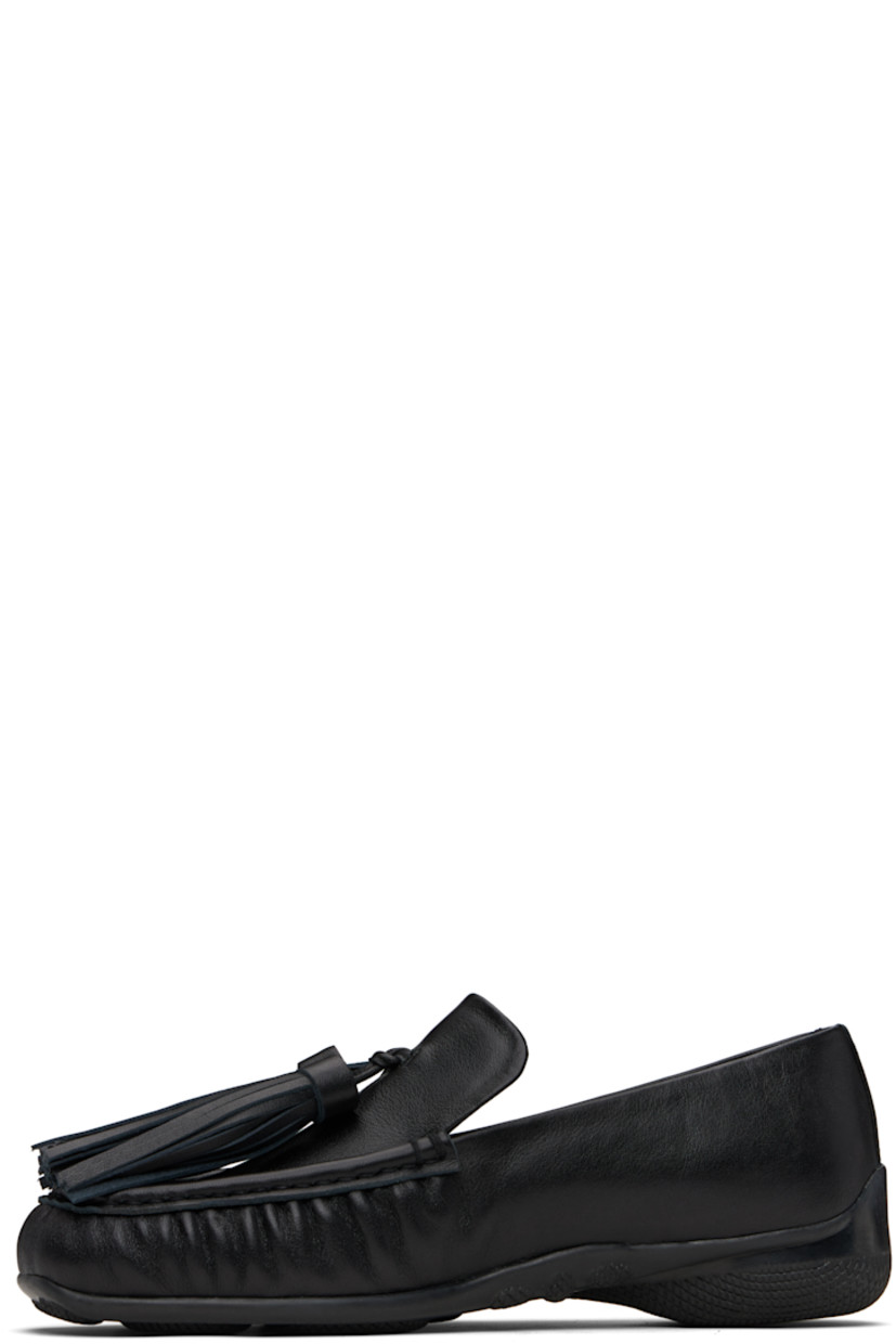 Buffed leather loafers.

· Square moc toe
· Tassels at vamp
· Treaded rubber sole

Supplier color: Black