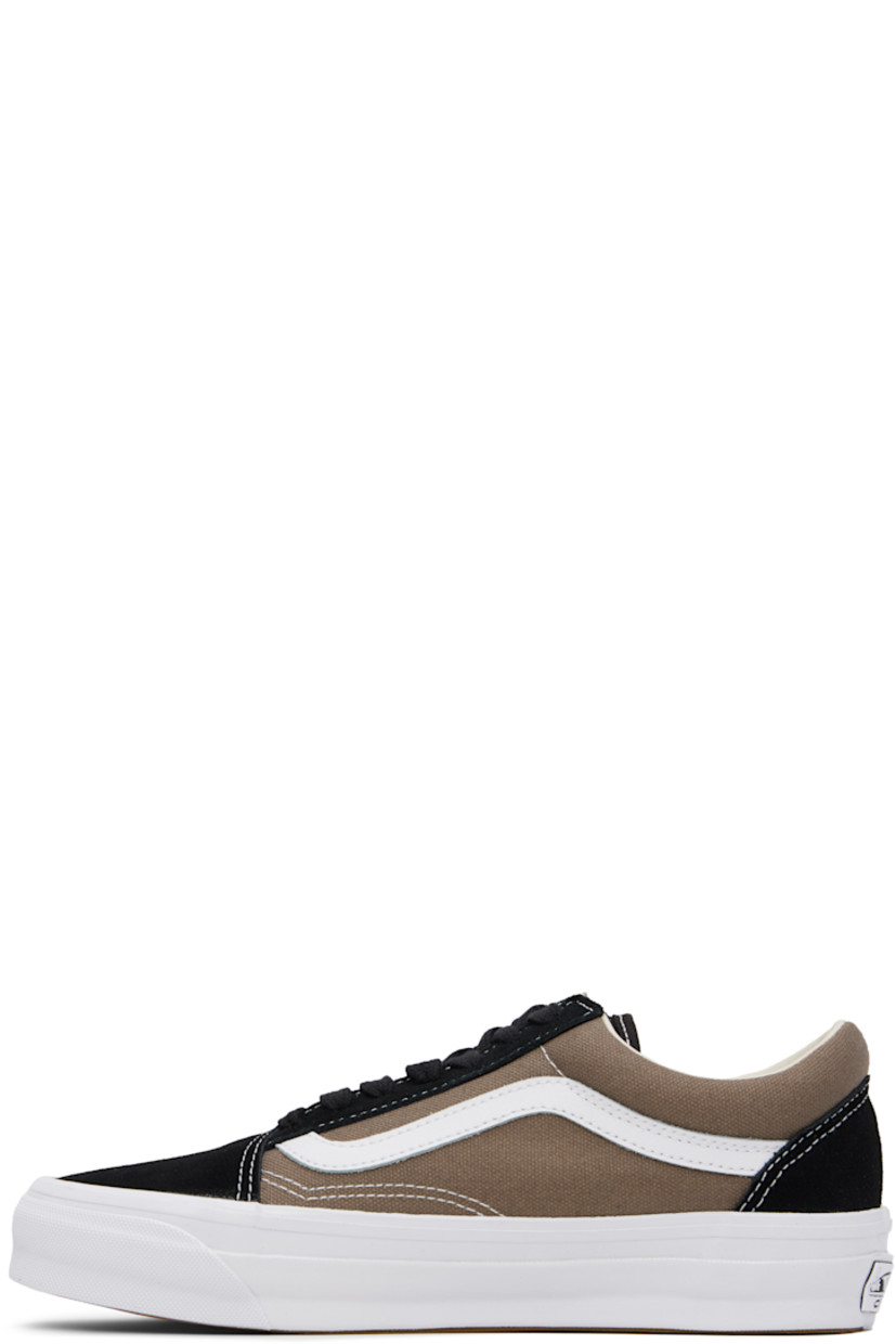Low-top 8 oz canvas and suede sneakers in black and taupe. 

· Lace-up closure
· Padded collar
· Padded tongue and collar
· Grained leather Sidestripe™
· Padded Sola ADC foam footbed 
· Rubberized logo patch at heel midsole
· Treaded rubber sole
· Contrast stitching in white

Supplier color: Santorini walnut grey/Black
