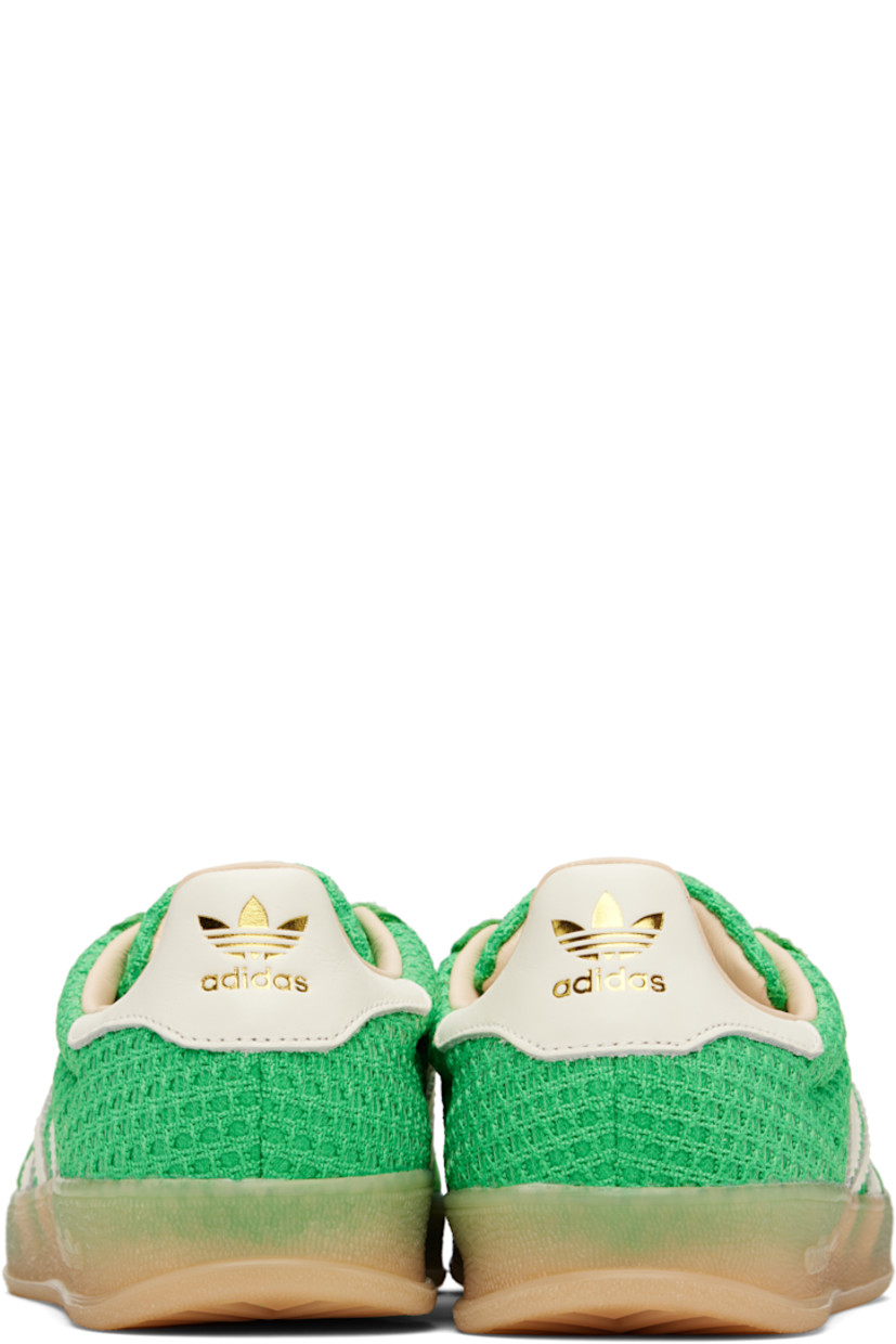 Low-top mesh, grained faux-leather, and faux-suede sneakers in green.

· Lace-up closure
· Padded collar
· Signature serrated stripes at sides
· Logo printed at heel tab
· Grained leather lining
· Logo embossed at textured rubber midsole
· Treaded rubber sole

Supplier color: Energy green/Off white/Magic beige