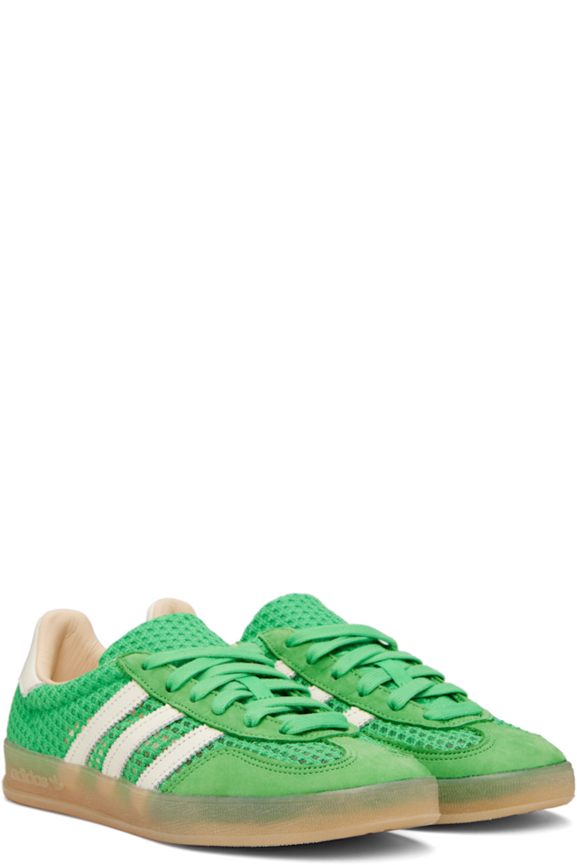 Low-top mesh, grained faux-leather, and faux-suede sneakers in green.

· Lace-up closure
· Padded collar
· Signature serrated stripes at sides
· Logo printed at heel tab
· Grained leather lining
· Logo embossed at textured rubber midsole
· Treaded rubber sole

Supplier color: Energy green/Off white/Magic beige