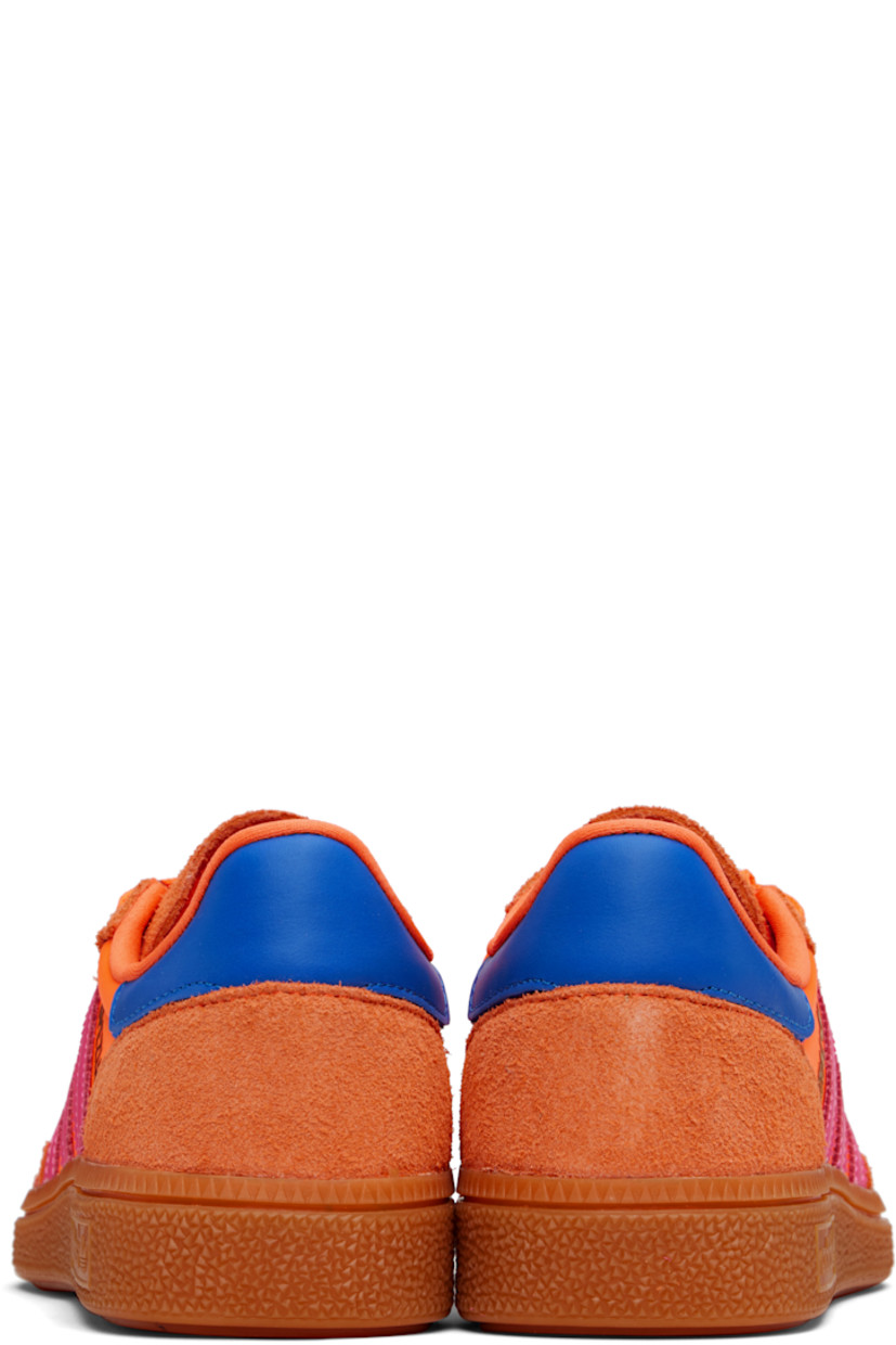 Low-top satin sneakers.

· Suede trim throughout
· Lace-up closure
· Logo patch at tongue
· Padded collar
· Signature serrated stripes at sides
· Text bonded at outer side
· Jersey lining
· Logo embossed at textured rubber midsole
· Treaded rubber sole

Supplier color: Solar orange/Lucid pink/Gum