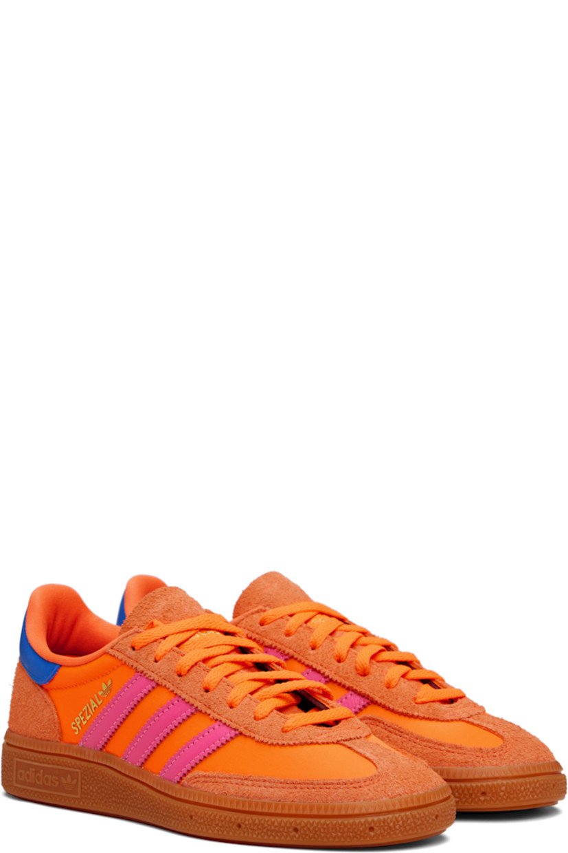 Low-top satin sneakers.

· Suede trim throughout
· Lace-up closure
· Logo patch at tongue
· Padded collar
· Signature serrated stripes at sides
· Text bonded at outer side
· Jersey lining
· Logo embossed at textured rubber midsole
· Treaded rubber sole

Supplier color: Solar orange/Lucid pink/Gum