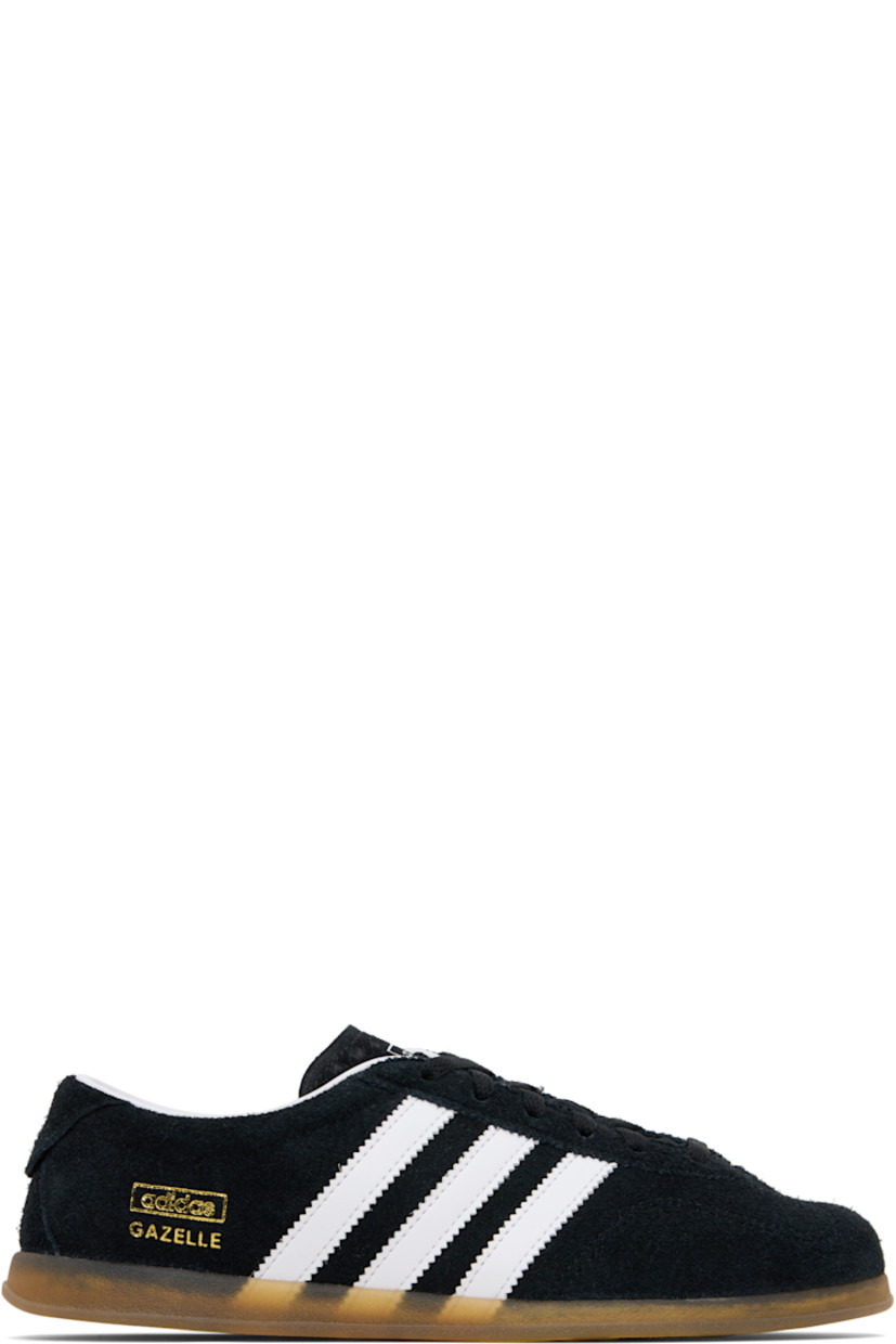 Low-top faux-suede sneakers.

· Lace-up closure
· Logo printed at tongue
· Padded collar
· Signature serrated stripes at sides
· Text stamp at outer side
· Grained faux-leather lining
· Treaded rubber sole

Supplier color: Black/White/Gum