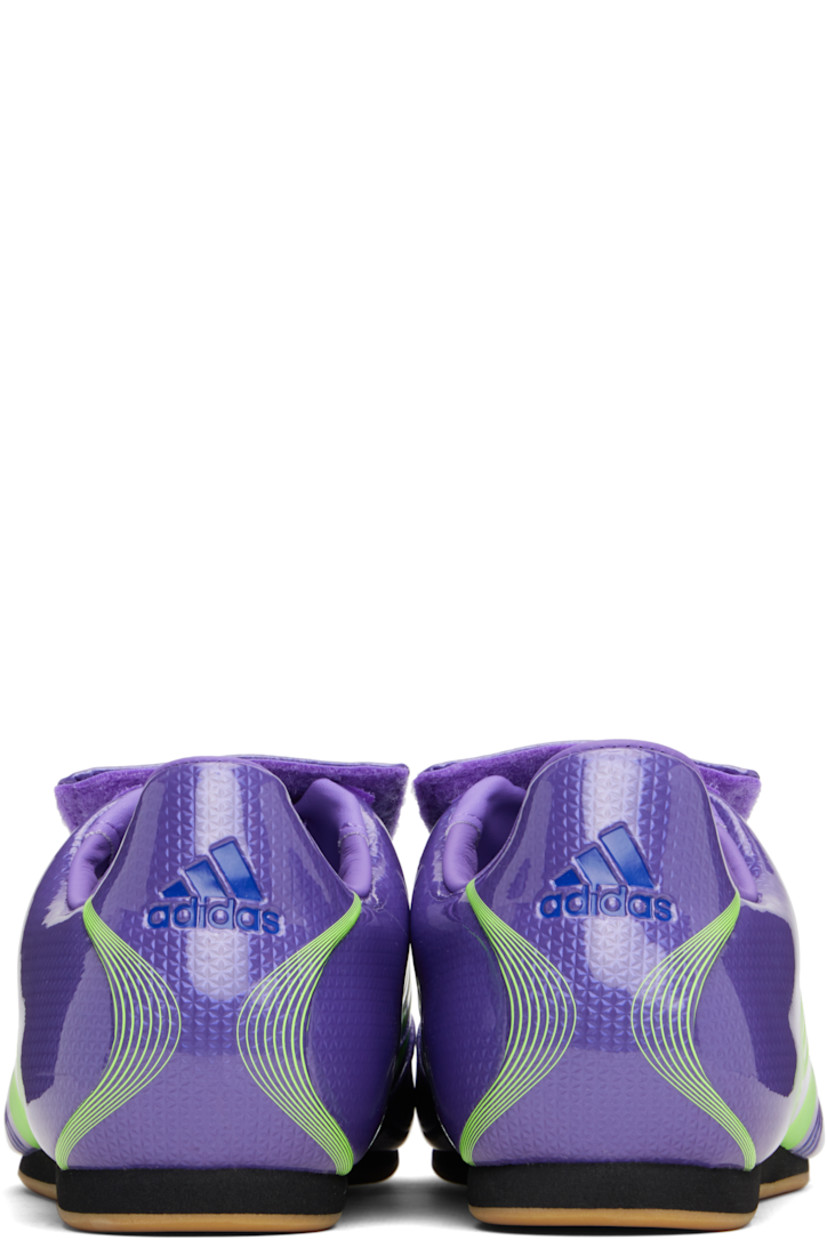 Low-top patent faux-leather sneakers.

· Stripes printed throughout
· Graphic printed at velcro closure
· Concealed elasticized gusset at vamp
· Padded collar
· Text stamp at outer side
· Logo printed at heel tab
· Jersey lining
· Foam rubber midsole
· Treaded rubber sole

Supplier color: Purple rush/Lucid lemon/Royal blue