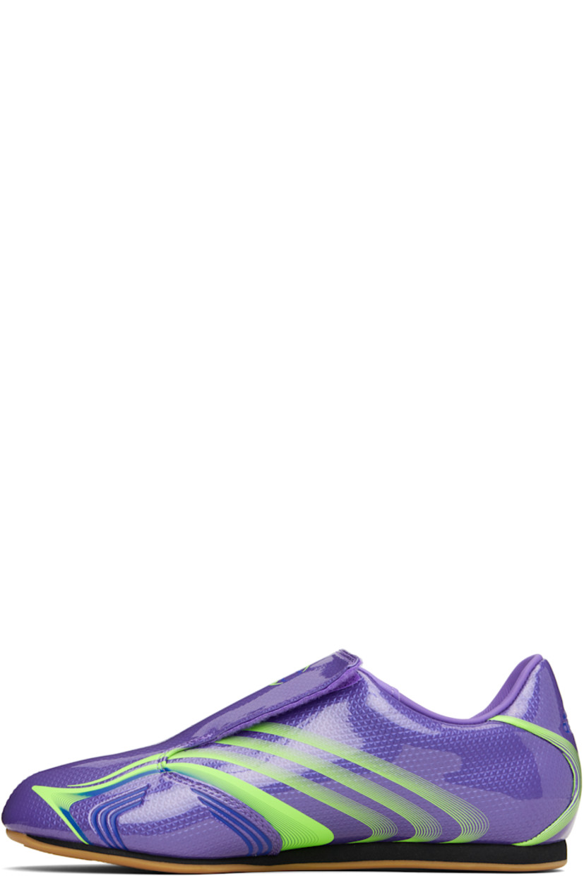 Low-top patent faux-leather sneakers.

· Stripes printed throughout
· Graphic printed at velcro closure
· Concealed elasticized gusset at vamp
· Padded collar
· Text stamp at outer side
· Logo printed at heel tab
· Jersey lining
· Foam rubber midsole
· Treaded rubber sole

Supplier color: Purple rush/Lucid lemon/Royal blue
