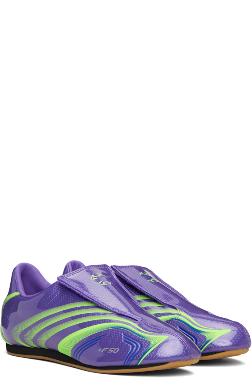 Low-top patent faux-leather sneakers.

· Stripes printed throughout
· Graphic printed at velcro closure
· Concealed elasticized gusset at vamp
· Padded collar
· Text stamp at outer side
· Logo printed at heel tab
· Jersey lining
· Foam rubber midsole
· Treaded rubber sole

Supplier color: Purple rush/Lucid lemon/Royal blue