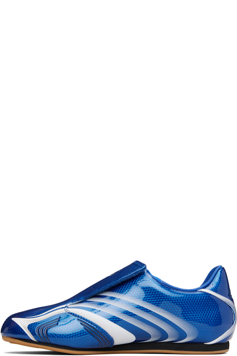 Low-top patent faux-leather sneakers.

· Stripes printed throughout
· Graphic printed at velcro closure
· Concealed elasticized gusset at vamp
· Padded collar
· Text stamp at outer side
· Logo printed at heel tab
· Jersey lining
· Foam rubber midsole
· Treaded rubber sole

Supplier color: Team royal blue/White
