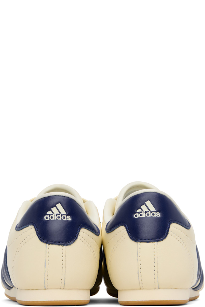 Low-top buffed leather sneakers.

· Quilted detailing at toe
· Logo embossed at vamp and heel tab
· Concealed elasticized gusset
· Padded tongue and collar
· Signature stripes and perforations at sides
· Buffed leather and mesh lining
· Treaded rubber sole

Supplier color: Cream white/Victory blue/Gum