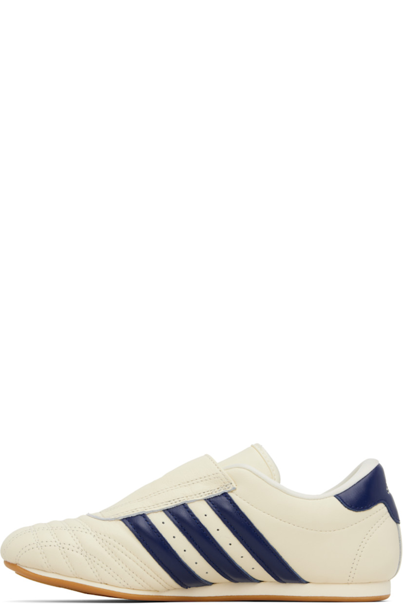 Low-top buffed leather sneakers.

· Quilted detailing at toe
· Logo embossed at vamp and heel tab
· Concealed elasticized gusset
· Padded tongue and collar
· Signature stripes and perforations at sides
· Buffed leather and mesh lining
· Treaded rubber sole

Supplier color: Cream white/Victory blue/Gum