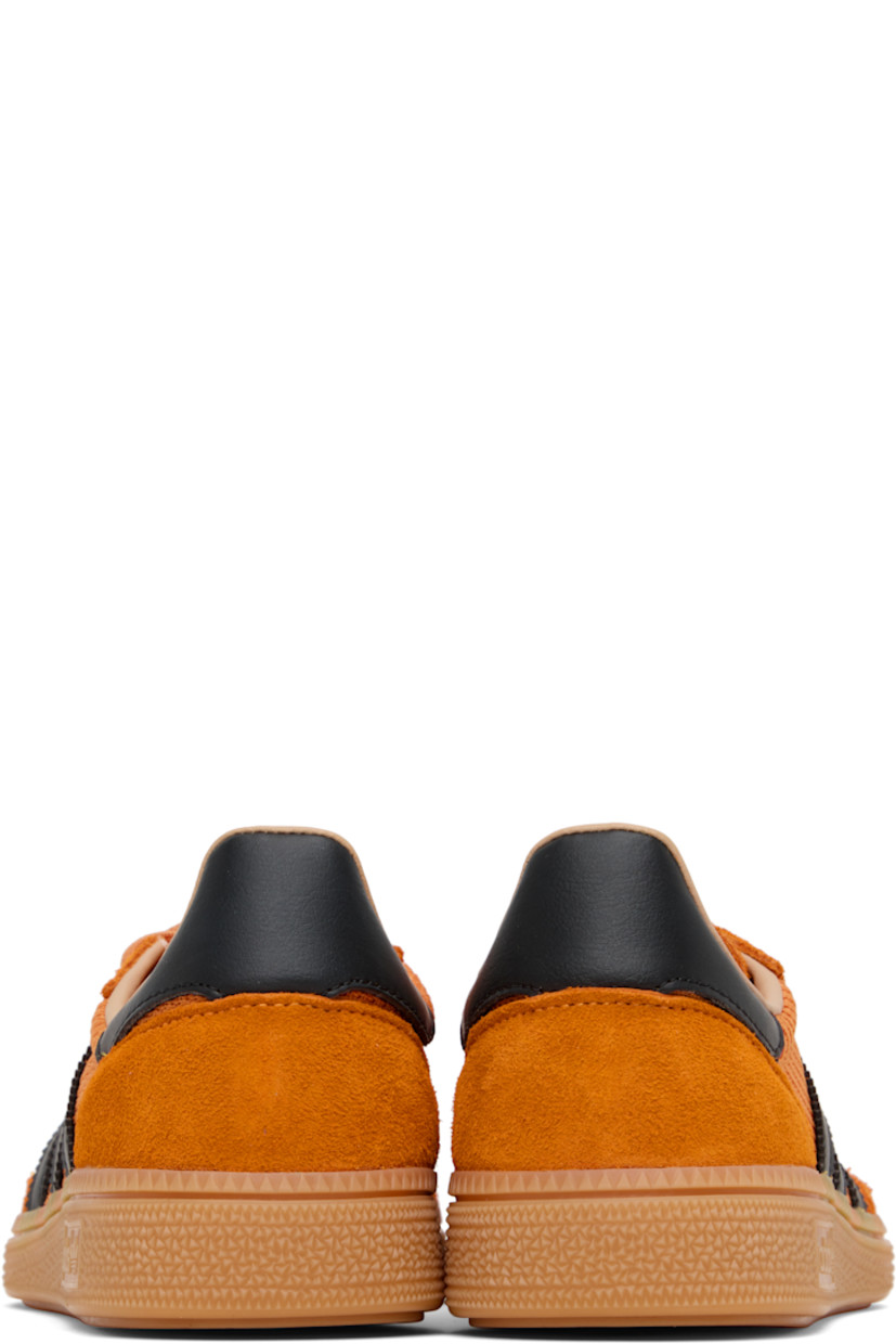 Low-top paneled mesh, suede, and buffed faux-leather sneakers.

· Lace-up closure
· Logo patch at tongue
· Padded collar
· Signature serrated stripes at sides
· Perforations at midsole 
· Treaded rubber sole 

Supplier color: Crew orange/Core black/Warm sandstone