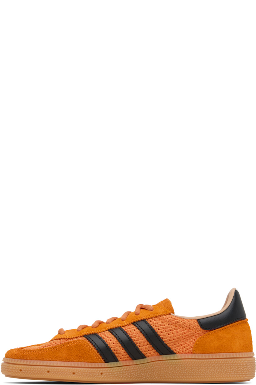 Low-top paneled mesh, suede, and buffed faux-leather sneakers.

· Lace-up closure
· Logo patch at tongue
· Padded collar
· Signature serrated stripes at sides
· Perforations at midsole 
· Treaded rubber sole 

Supplier color: Crew orange/Core black/Warm sandstone