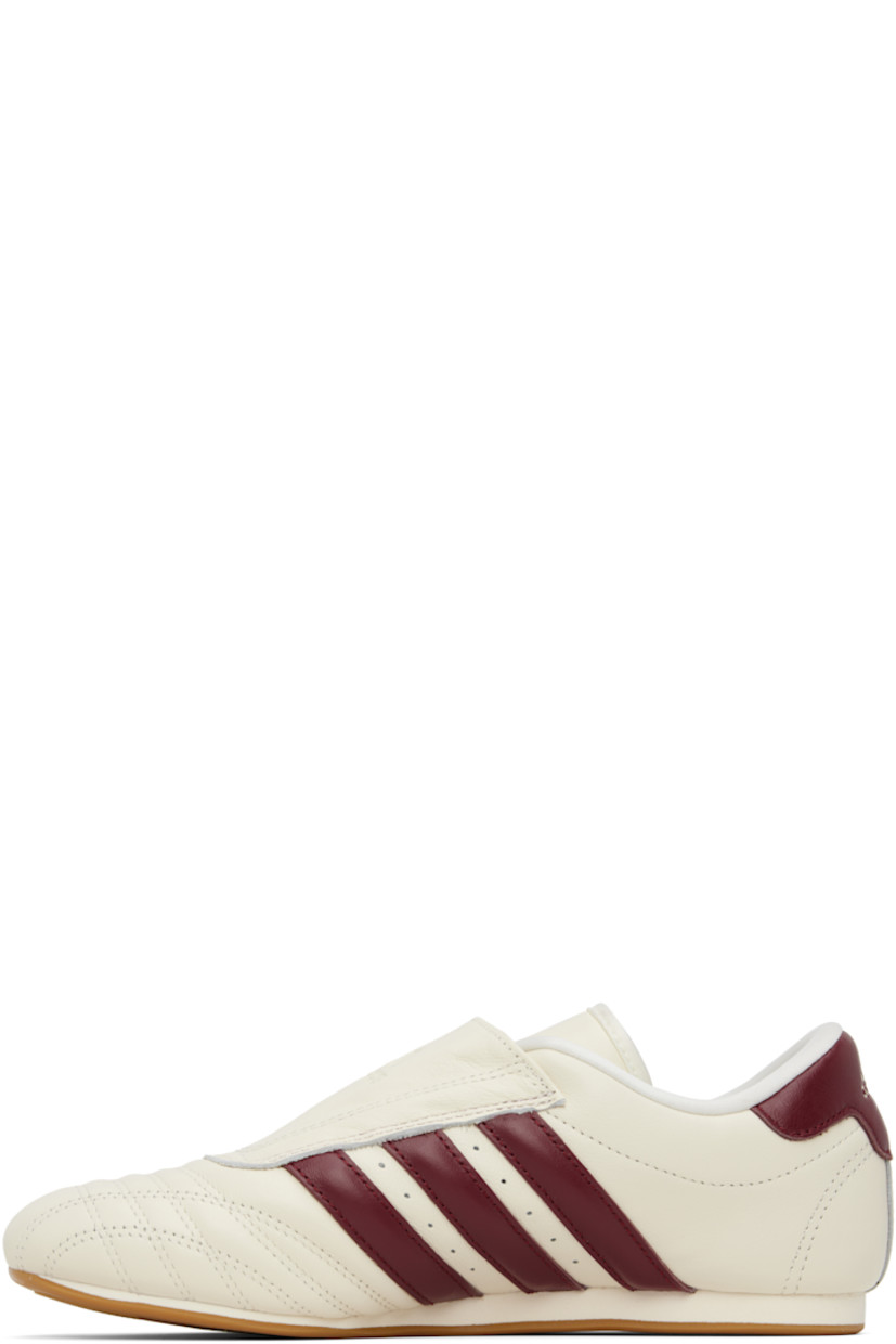 Low-top buffed leather sneakers.

· Quilted detailing at toe
· Logo embossed at vamp and heel tab
· Concealed elasticized gusset
· Padded tongue and collar
· Signature stripes and perforations at sides
· Buffed leather and mesh lining
· Treaded rubber sole

Supplier color: Off white/Noble maroon