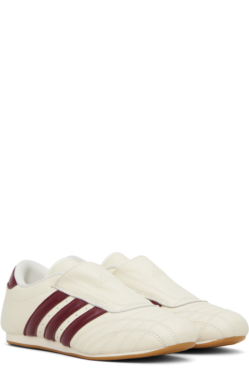 Low-top buffed leather sneakers.

· Quilted detailing at toe
· Logo embossed at vamp and heel tab
· Concealed elasticized gusset
· Padded tongue and collar
· Signature stripes and perforations at sides
· Buffed leather and mesh lining
· Treaded rubber sole

Supplier color: Off white/Noble maroon
