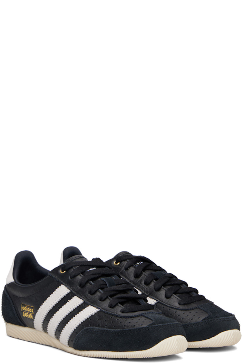 Low-top tumbled grained leather sneakers.

· Brushed suede trim throughout
· Perforations at toe and sides  
· Lace-up closure
· Logo patch at tongue 
· Padded collar 
· Signature stripes with serrated edges at sides
· Logo stamp at outer side
· Logo embossed at heel tab
· Treaded rubber sole 

Supplier color: Core black/Cloud white/Gold metallic
