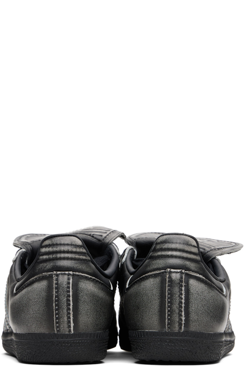 Low-top buffed leather sneakers.

· Fading throughout
· Quilted toe and heel tab
· Lace-up closure
· Logo-embossed at extended foldover tongue
· Padded collar
· Text stamp at outer side
· Signature serrated stripes at sides
· Mesh lining
· Treaded rubber sole

Supplier color: Core black/Core black/Cloud white