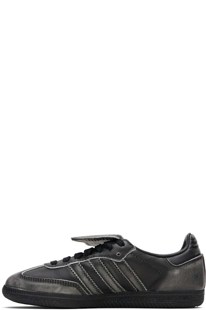 Low-top buffed leather sneakers.

· Fading throughout
· Quilted toe and heel tab
· Lace-up closure
· Logo-embossed at extended foldover tongue
· Padded collar
· Text stamp at outer side
· Signature serrated stripes at sides
· Mesh lining
· Treaded rubber sole

Supplier color: Core black/Core black/Cloud white