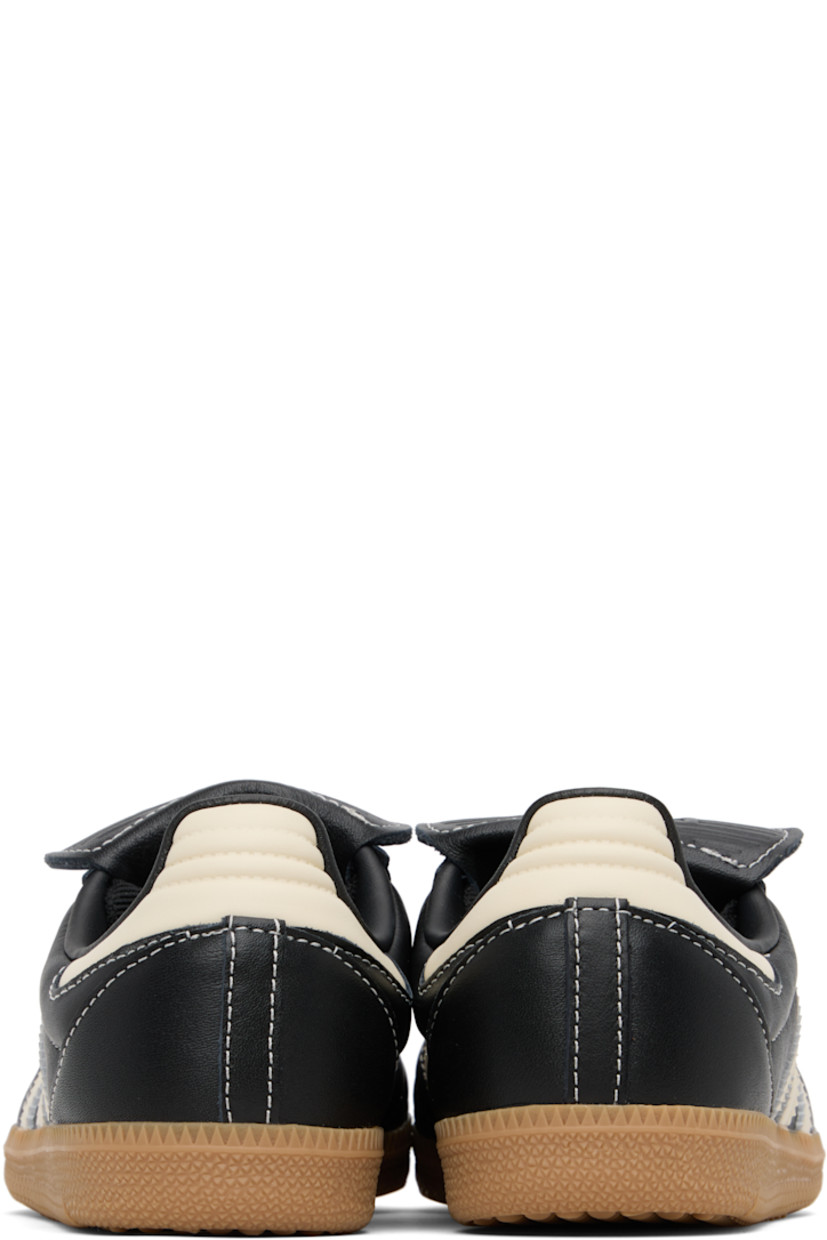 Low-top quilted buffed leather sneakers.

· Lace-up closure
· Logo embossed at extended tongue
· Padded collar
· Signature serrated stripes at sides
· Text stamp at outer side
· Grained faux-leather lining
· Treaded rubber sole
· Contrast stitching in white

Supplier color: Core black/Cream white/Gum