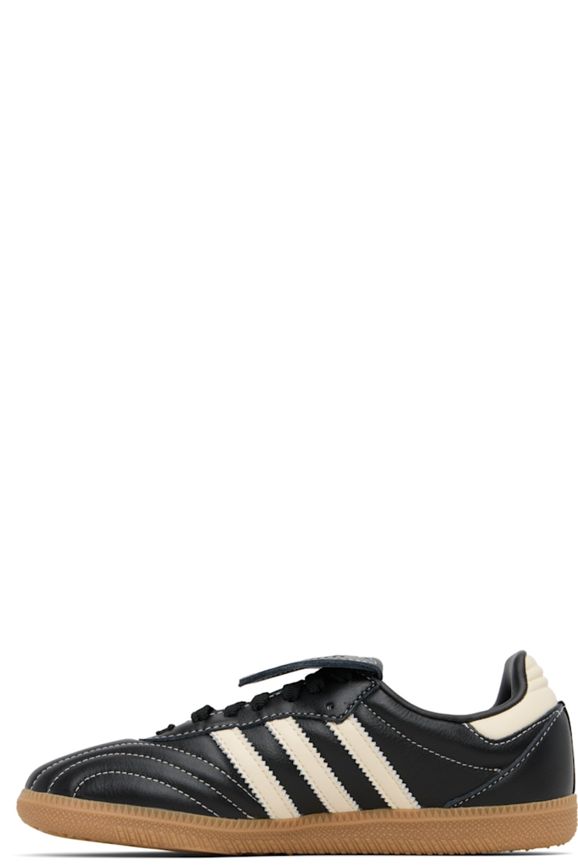 Low-top quilted buffed leather sneakers.

· Lace-up closure
· Logo embossed at extended tongue
· Padded collar
· Signature serrated stripes at sides
· Text stamp at outer side
· Grained faux-leather lining
· Treaded rubber sole
· Contrast stitching in white

Supplier color: Core black/Cream white/Gum
