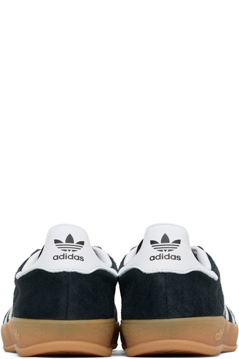 Low-top suede and buffed leather sneakers.

· Lace-up closure
· Logo printed at tongue
· Padded collar
· Text stamp at outer side
· Signature serrated stripes at sides
· Buffed leather lining
· Treaded rubber sole

Supplier color: Core black/Future white/Gum