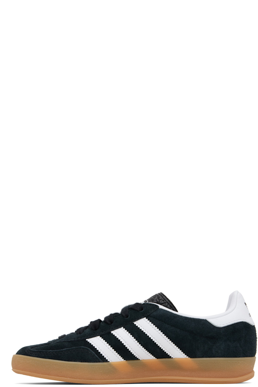 Low-top suede and buffed leather sneakers.

· Lace-up closure
· Logo printed at tongue
· Padded collar
· Text stamp at outer side
· Signature serrated stripes at sides
· Buffed leather lining
· Treaded rubber sole

Supplier color: Core black/Future white/Gum