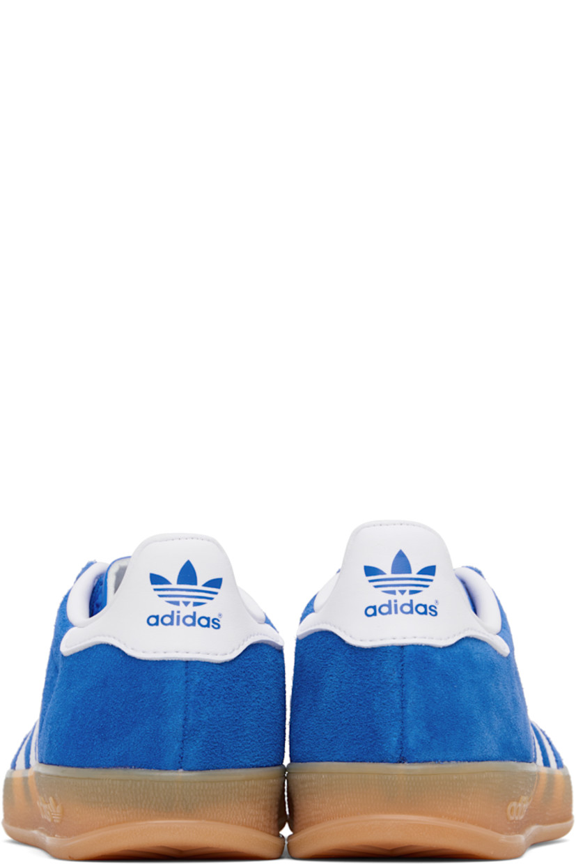 Low-top suede and buffed leather sneakers.

· Lace-up closure
· Logo printed at tongue
· Padded collar
· Text stamp at outer side
· Signature serrated stripes at sides
· Buffed leather lining
· Treaded rubber sole

Supplier color: Bluebird/Future white/Gum