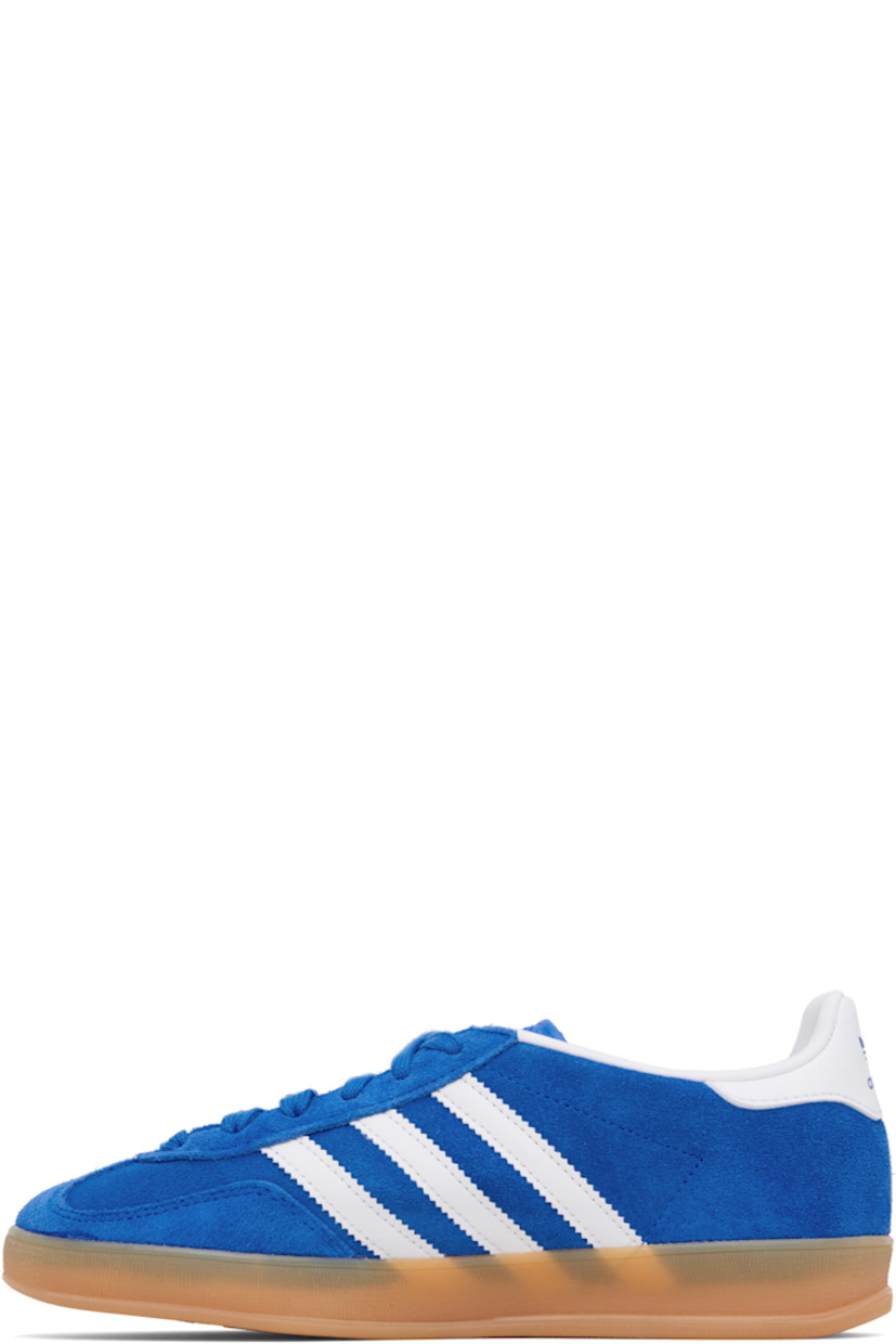 Low-top suede and buffed leather sneakers.

· Lace-up closure
· Logo printed at tongue
· Padded collar
· Text stamp at outer side
· Signature serrated stripes at sides
· Buffed leather lining
· Treaded rubber sole

Supplier color: Bluebird/Future white/Gum