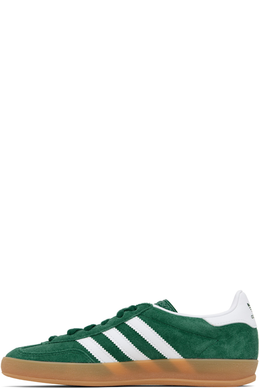 Low-top suede and buffed leather sneakers.

· Lace-up closure
· Logo printed at tongue
· Padded collar
· Text stamp at outer side
· Signature serrated stripes at sides
· Buffed leather lining
· Treaded rubber sole

Supplier color: Collegiate green/Cloud white/Gum