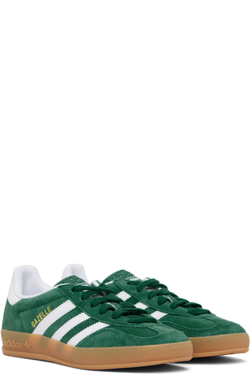 Low-top suede and buffed leather sneakers.

· Lace-up closure
· Logo printed at tongue
· Padded collar
· Text stamp at outer side
· Signature serrated stripes at sides
· Buffed leather lining
· Treaded rubber sole

Supplier color: Collegiate green/Cloud white/Gum