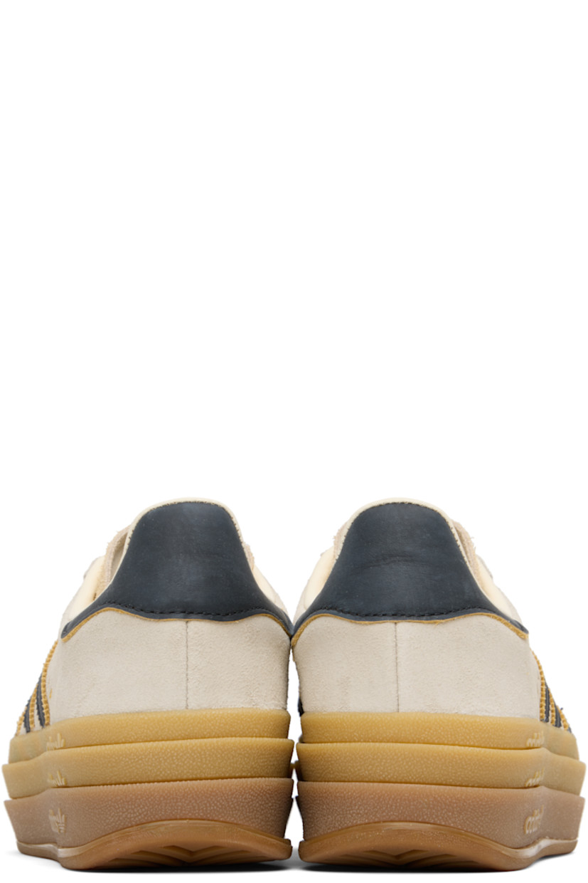 Low-top suede sneakers.

· Lace-up closure
· Logo printed at tongue
· Padded collar
· Signature serrated stripes at sides
· Logo printed at outer side
· Faux-leather and jersey lining
· Logo embossed at stacked rubber midsole
· Treaded rubber sole
· Platform: H1.75"
 
Supplier color: Cream white/Core black/Sand strata