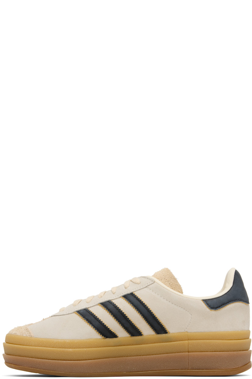 Low-top suede sneakers.

· Lace-up closure
· Logo printed at tongue
· Padded collar
· Signature serrated stripes at sides
· Logo printed at outer side
· Faux-leather and jersey lining
· Logo embossed at stacked rubber midsole
· Treaded rubber sole
· Platform: H1.75"
 
Supplier color: Cream white/Core black/Sand strata