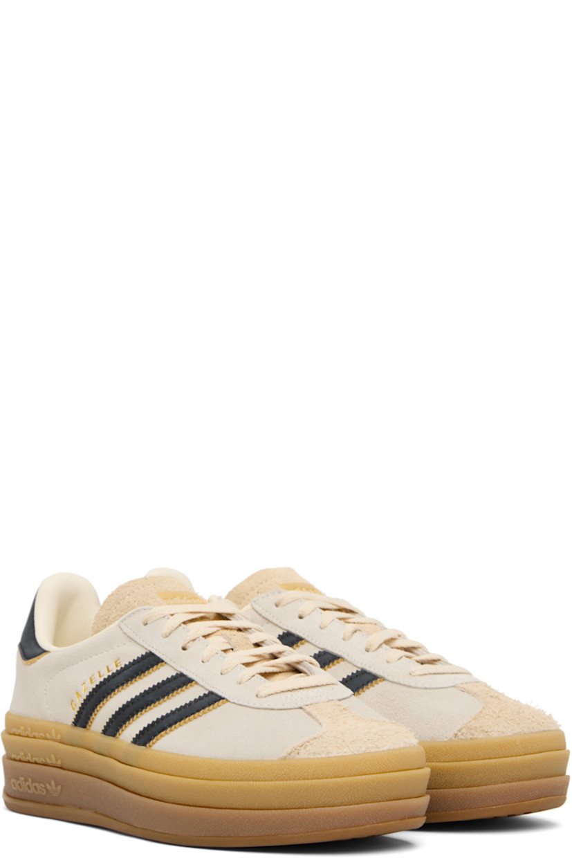 Low-top suede sneakers.

· Lace-up closure
· Logo printed at tongue
· Padded collar
· Signature serrated stripes at sides
· Logo printed at outer side
· Faux-leather and jersey lining
· Logo embossed at stacked rubber midsole
· Treaded rubber sole
· Platform: H1.75"
 
Supplier color: Cream white/Core black/Sand strata