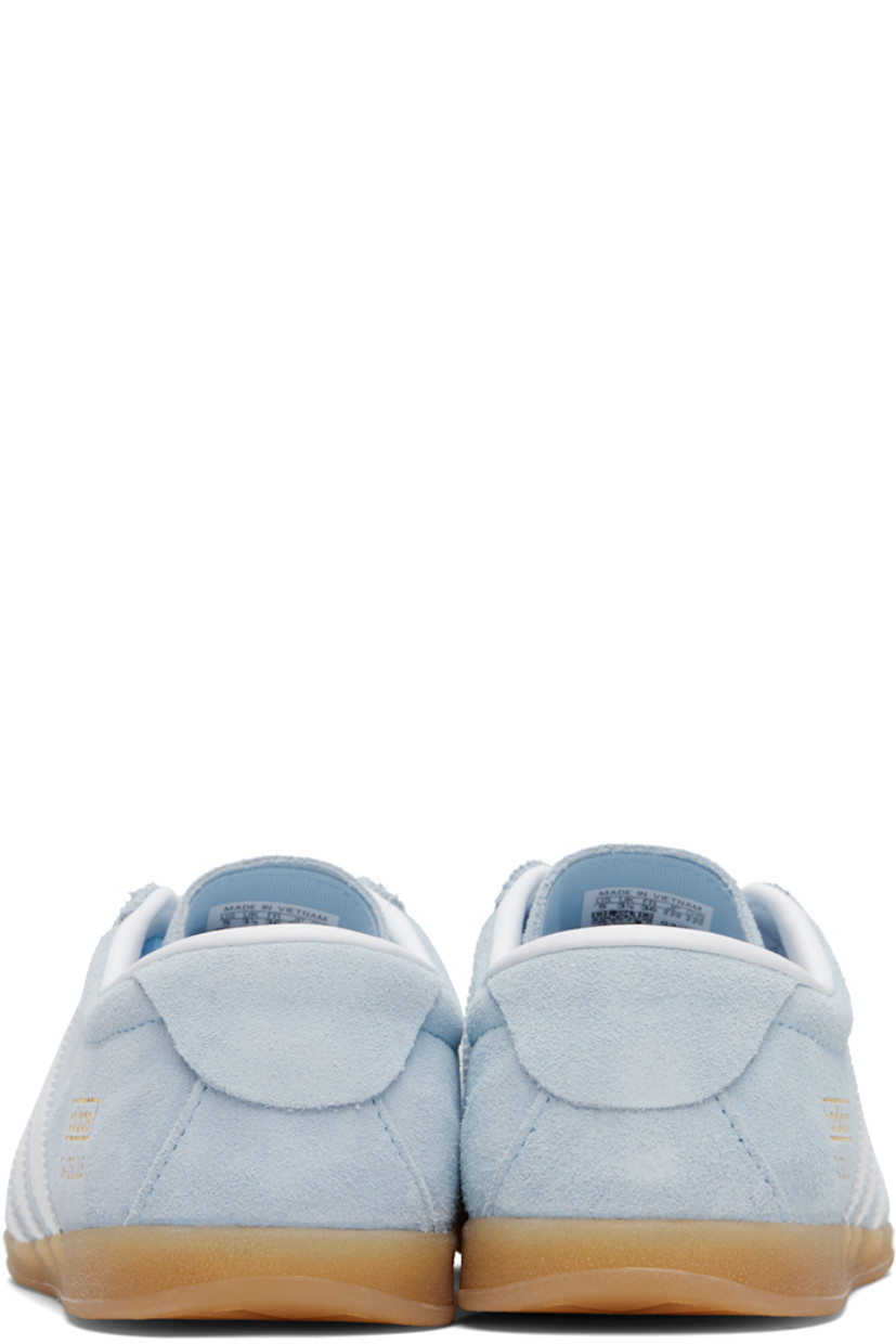 Low-top suede sneakers.

· Lace-up closure
· Logo printed at tongue
· Padded collar
· Signature serrated stripes at sides
· Logo and text stamp at outer side
· Jersey lining
· Treaded rubber sole

Supplier color: Clear sky/Cloud white/Gum