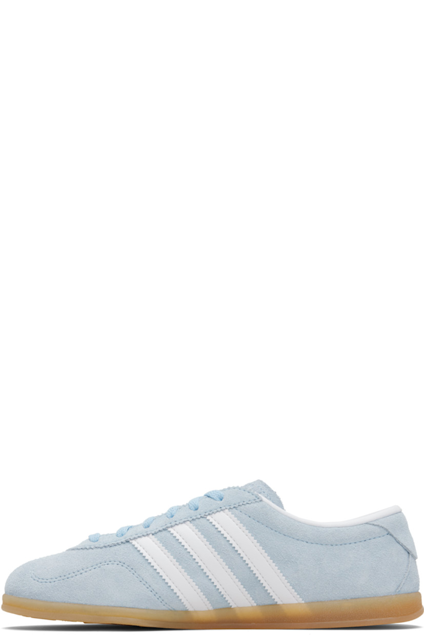 Low-top suede sneakers.

· Lace-up closure
· Logo printed at tongue
· Padded collar
· Signature serrated stripes at sides
· Logo and text stamp at outer side
· Jersey lining
· Treaded rubber sole

Supplier color: Clear sky/Cloud white/Gum