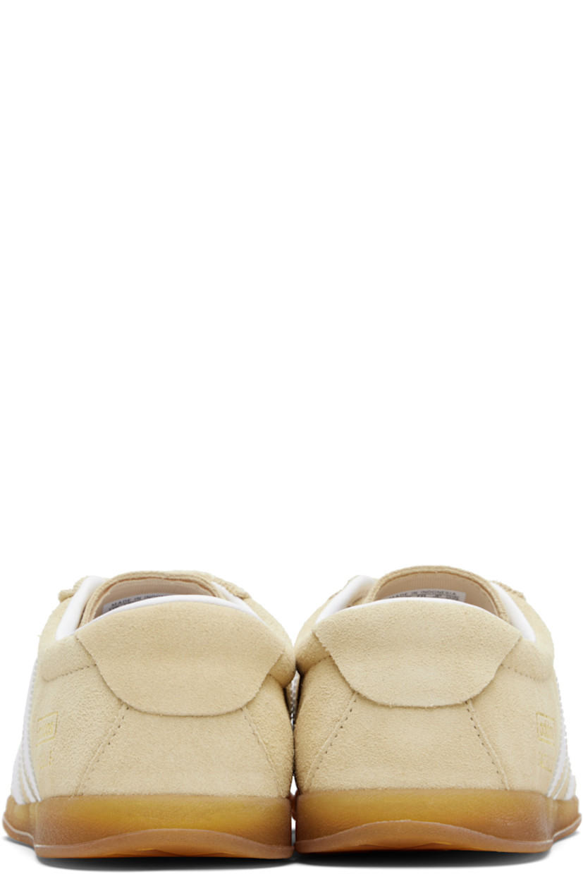 Low-top suede sneakers.

· Lace-up closure
· Logo printed at tongue
· Padded collar
· Signature serrated stripes at sides
· Logo and text stamp at outer side
· Jersey lining
· Treaded rubber sole

Supplier color: Sand strata/Cloud white/Gum
