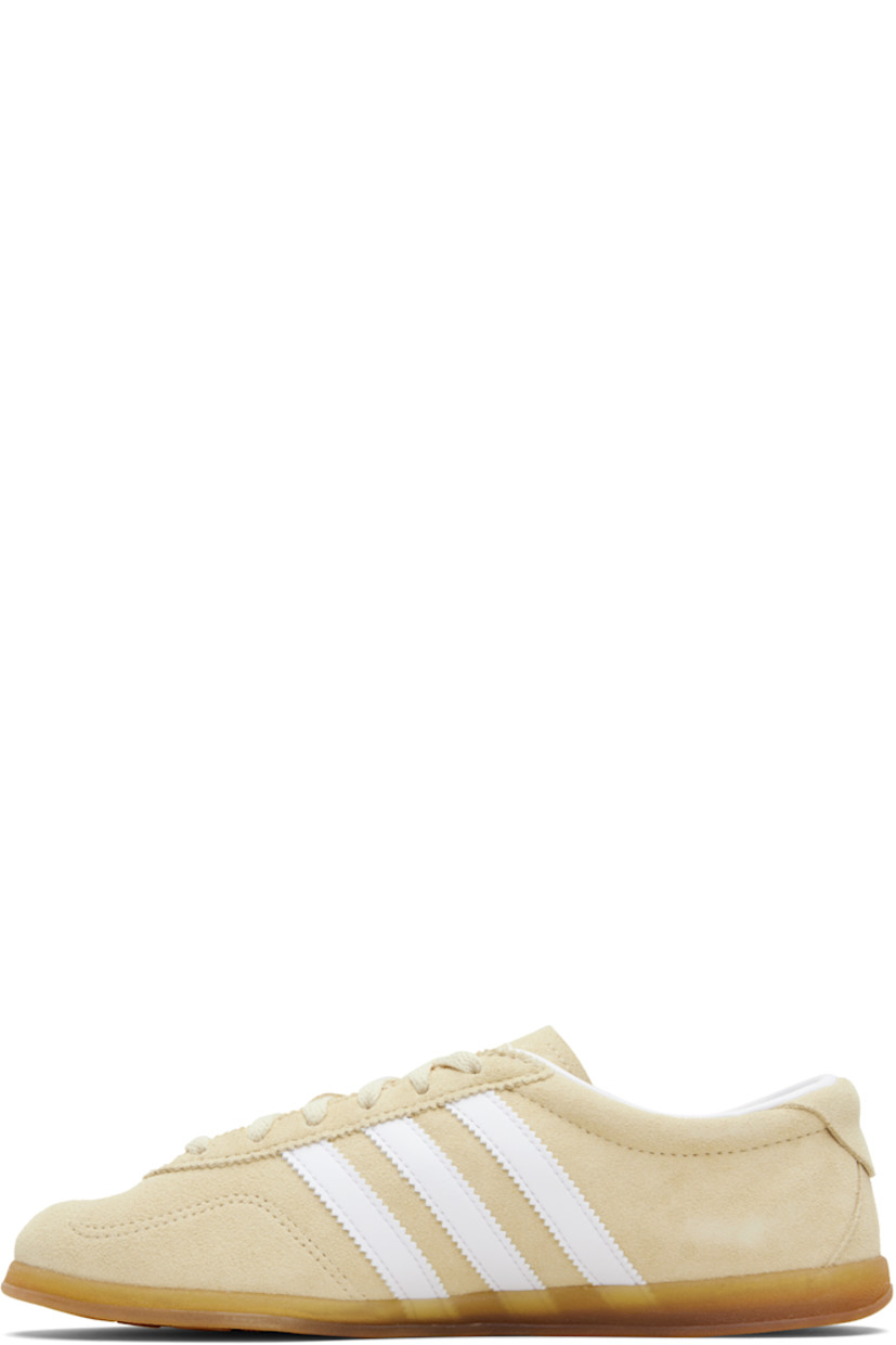 Low-top suede sneakers.

· Lace-up closure
· Logo printed at tongue
· Padded collar
· Signature serrated stripes at sides
· Logo and text stamp at outer side
· Jersey lining
· Treaded rubber sole

Supplier color: Sand strata/Cloud white/Gum