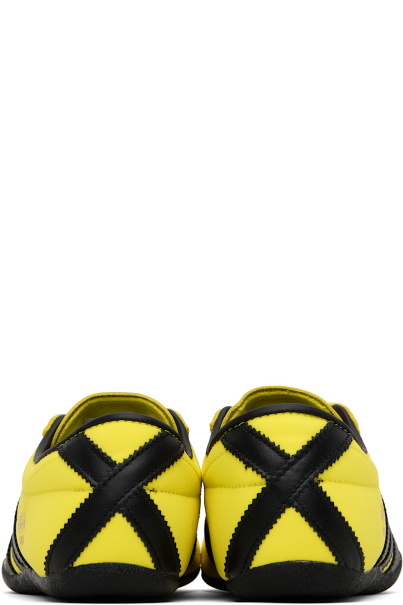 Low-top canvas, buffed leather, and suede sneakers.

· Lace-up closure
· Logo bonded at padded tongue
· Padded collar
· Signature serrated stripes at sides and heel
· Logo stamp at outer side
· Buffed faux-leather and mesh lining
· Crêpe-rubber sole

Supplier color: Pure sulfur/Dark brown/Gold metallic