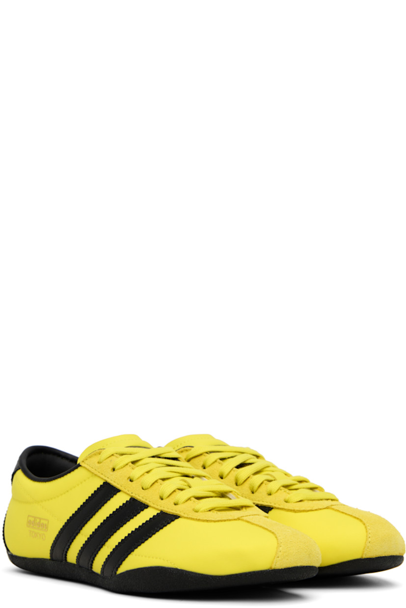 Low-top canvas, buffed leather, and suede sneakers.

· Lace-up closure
· Logo bonded at padded tongue
· Padded collar
· Signature serrated stripes at sides and heel
· Logo stamp at outer side
· Buffed faux-leather and mesh lining
· Crêpe-rubber sole

Supplier color: Pure sulfur/Dark brown/Gold metallic