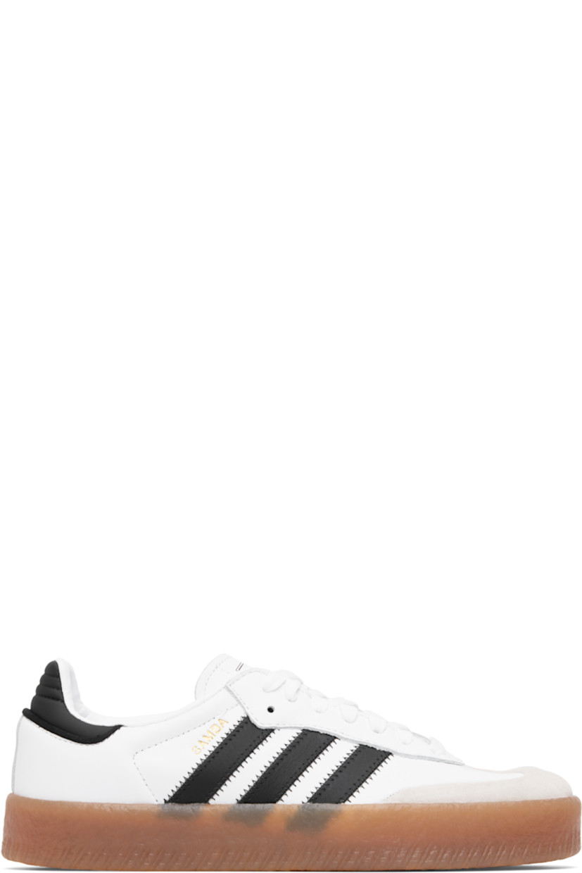 Low-top buffed leather and nubuck sneakers.

· Lace-up closure
· Logo printed at tongue
· Padded collar
· Text stamp at outer side
· Signature serrated stripes at sides
· Quilted heel tab
· Mesh lining
· Treaded gum rubber sole

Supplier color: Cloud white/Core black/Gold metallic